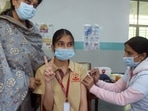 A girl shows victory sign while receiving her first dose of Bharat Biotech's Covaxin against the COVID-19 virus during a vaccination drive for children aged 15-18 years, at DAV Public School, in Gurugram.(ANI) A girl shows victory sign while receiving her first dose of Bharat Biotech's Covaxin against the COVID-19 virus during a vaccination drive for children aged 15-18 years, at DAV Public School, in Gurugram.(ANI)