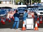 Healthcare workers wait for the next vehicle at a coronavirus disease (Covid-19) testing clinic as the Omicron coronavirus variant continues to spread in Sydney, Australia.&nbsp;