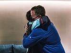 Nadia Popovici (L) is embraced by Vancouver Canucks's assistant equipment manager, Brian Hamilton, in Seattle on January 1, 2022. (AFP) Nadia Popovici (L) is embraced by Vancouver Canucks's assistant equipment manager, Brian Hamilton, in Seattle on January 1, 2022. (AFP)