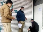Police personnel sealing a shop for not following Covid-19 appropriate behaviour, at Malviya Nagar, in New Delhi on Sunday. Police personnel sealing a shop for not following Covid-19 appropriate behaviour, at Malviya Nagar, in New Delhi on Sunday.