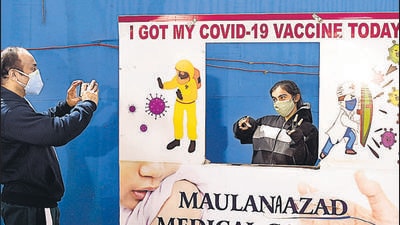 A parent takes a picture of his ward during a vaccination drive for children in the age group of 15 to 18 years at RML Hospital in New Delhi on Monday. (Arvind Yadav/HT Photo)