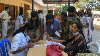 Students register their names before receiving a dose of the Covaxin vaccine against the Covid-19 coronavirus during a vaccination drive at the Nelamangala Government High School and Junior College in Bangalore on January 3. (AFP) Students register their names before receiving a dose of the Covaxin vaccine against the Covid-19 coronavirus during a vaccination drive at the Nelamangala Government High School and Junior College in Bangalore on January 3. (AFP)