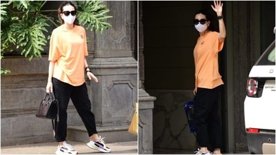 Karisma wore a baggy orange T-shirt with droopy sleeves, a round neckline and a long hem. She teamed it with a pair of black mom denim jeans featuring folded hem. (HT Photo/Varinder Chawla) Karisma wore a baggy orange T-shirt with droopy sleeves, a round neckline and a long hem. She teamed it with a pair of black mom denim jeans featuring folded hem. (HT Photo/Varinder Chawla)