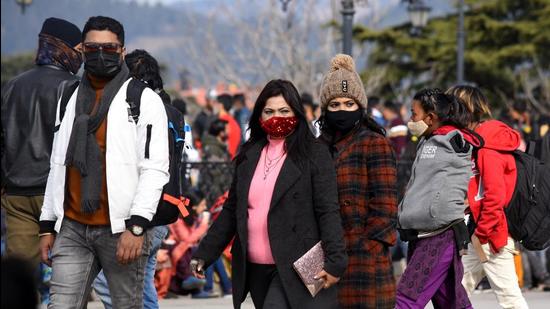Tourists strolling on a cold day on The Ridge in Shimla on Monday. (Deepak Sansta/HT)