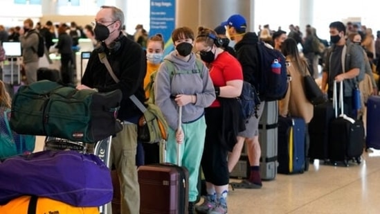 The cancellations, coupled with more than 5,000 flight delays on Monday, just add to the despair felt over the weekend by holidays travelers trying to get home. In picture - Travelers wait in the ticketing line at Salt Lake City International Airport in Salt Lake City.(AP)