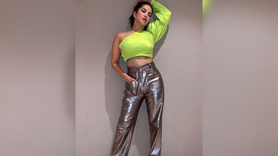 The gorgeous Sunny Leone opted for a neon green asymmetrical crop top and silver straight-cut pants.(Instagram/@sunnyleone)