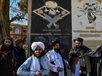 Taliban provincial culture chief Mullah Habibullah Mujahid (R) stands with Taliban members next to a section of a wall of a former US military base with the names of US soldiers in Ghazni. Taliban provincial culture chief Mullah Habibullah Mujahid (R) stands with Taliban members next to a section of a wall of a former US military base with the names of US soldiers in Ghazni.