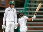 Temba Bavuma, standing with teammate Marco Jansen, raises his bat after reaching half century(AP) Temba Bavuma, standing with teammate Marco Jansen, raises his bat after reaching half century(AP)