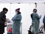 Healthcare workers administer the Covid-19 PCR test at a free test site in Farragut Square in Washington, DC.&nbsp;