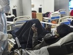 A health worker interacts with a Covid-19 patient at a Covid care centre in New Delhi.(PTI Photo) A health worker interacts with a Covid-19 patient at a Covid care centre in New Delhi.(PTI Photo)