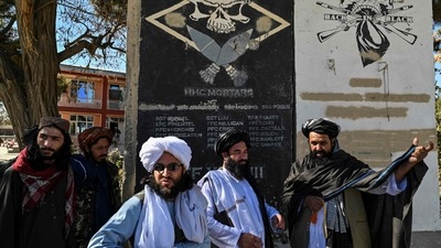 Taliban provincial culture chief Mullah Habibullah Mujahid (R) stands with Taliban members next to a section of a wall of a former US military base with the names of US soldiers in Ghazni. (AFP) Taliban provincial culture chief Mullah Habibullah Mujahid (R) stands with Taliban members next to a section of a wall of a former US military base with the names of US soldiers in Ghazni. (AFP)