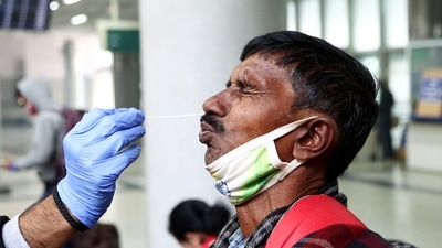 A healthcare worker collects a nasal swab sample of a passenger for the RT-PCR test amid the spike in new COVID-19 variant Omicron cases, at Kashmiri Gate ISBT, in New Delhi. (ANI) A healthcare worker collects a nasal swab sample of a passenger for the RT-PCR test amid the spike in new COVID-19 variant Omicron cases, at Kashmiri Gate ISBT, in New Delhi. (ANI)