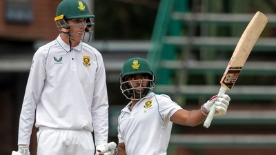 South Africa's batsman Temba Bavuma, right, whilst standing with teammate Marco Jansen, raises his bat after reaching a half century during the second day of the 2nd Test Cricket match between South Africa and India at the Wanderers stadium in Johannesburg, South Africa, Tuesday, Jan. 4, 2022. (AP Photo/Themba Hadebe) (AP) South Africa's batsman Temba Bavuma, right, whilst standing with teammate Marco Jansen, raises his bat after reaching a half century during the second day of the 2nd Test Cricket match between South Africa and India at the Wanderers stadium in Johannesburg, South Africa, Tuesday, Jan. 4, 2022. (AP Photo/Themba Hadebe) (AP)