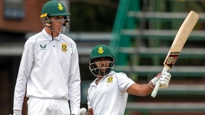 Temba Bavuma, standing with teammate Marco Jansen, raises his bat after reaching half century (AP) Temba Bavuma, standing with teammate Marco Jansen, raises his bat after reaching half century (AP)