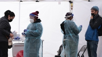 Healthcare workers administer the Covid-19 PCR test at a free test site in Farragut Square in Washington, DC. (AFP) Healthcare workers administer the Covid-19 PCR test at a free test site in Farragut Square in Washington, DC. (AFP)