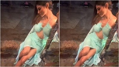 The Brahmastra actor chose a pastel blue beach-ready outfit for enjoying date night with her friends. Her ensemble features a halter neck bikini top with barely-there straps, inversed neckline, gathered details on the front and a midriff-baring hem. (Instagram/@imouniroy) The Brahmastra actor chose a pastel blue beach-ready outfit for enjoying date night with her friends. Her ensemble features a halter neck bikini top with barely-there straps, inversed neckline, gathered details on the front and a midriff-baring hem. (Instagram/@imouniroy)