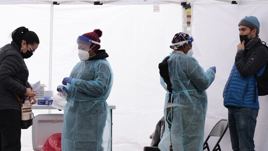 Healthcare workers administer the Covid-19 PCR test at a free test site in Farragut Square in Washington, DC.&nbsp;(AFP)