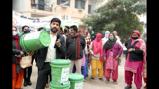 Residents taking part in a home composting activity in Chandigarh on Tuesday. (HT Photo)