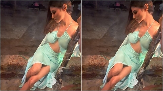 The Brahmastra actor chose a pastel blue beach-ready outfit for enjoying date night with her friends. Her ensemble features a halter neck bikini top with barely-there straps, inversed neckline, gathered details on the front and a midriff-baring hem.(Instagram/@imouniroy)