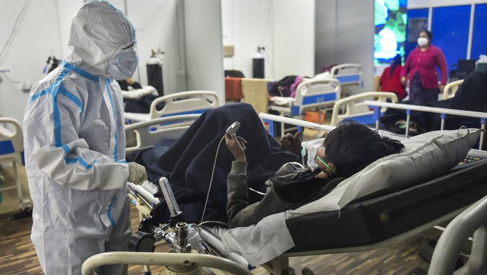 A health worker interacts with a Covid-19 patient at a Covid care centre in New Delhi. (PTI Photo) A health worker interacts with a Covid-19 patient at a Covid care centre in New Delhi. (PTI Photo)