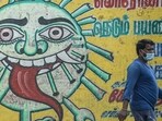 A man walks past a Covid-19 awareness mural in Chennai, Tamil Nadu. (AFP)