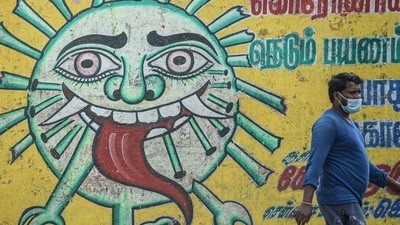 A man walks past a Covid-19 awareness mural in Chennai, Tamil Nadu. (AFP) A man walks past a Covid-19 awareness mural in Chennai, Tamil Nadu. (AFP)