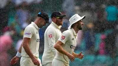 England's James Anderson, left, Jonny Bairstow and Mark Wood, right, as rain halts play on the first day of their Ashes cricket test match against Australia in Sydney. (AP) England's James Anderson, left, Jonny Bairstow and Mark Wood, right, as rain halts play on the first day of their Ashes cricket test match against Australia in Sydney. (AP)