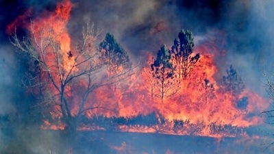 A fire burns near a home Thursday, Dec. 30, 2021, north of Boulder, Colo. (Cliff Grassmick/Daily Camera via AP)