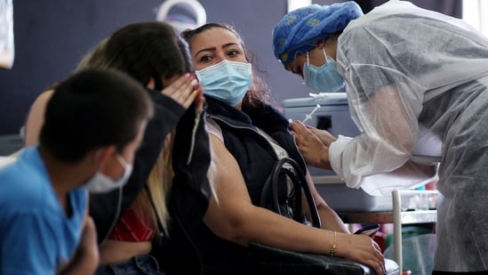 A healthcare worker inoculates a woman with a Covid-19 vaccine at a vaccination centre in Bogota, on Tuesday.(AFP Photo)
