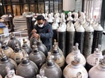 A staff checks the oxygen cylinders at a Covid care centre amid a surge in Omicron cases, at Commonwealth Games Village in New Delhi on Tuesday.(ANI Photo) A staff checks the oxygen cylinders at a Covid care centre amid a surge in Omicron cases, at Commonwealth Games Village in New Delhi on Tuesday.(ANI Photo)