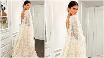 Tara Sutaria's lehenga featured a backless full-sleeve blouse with a plunging neckline, a full sequins lehenga and a see-through netted dupatta. (Instagram/@tarasutaria) Tara Sutaria's lehenga featured a backless full-sleeve blouse with a plunging neckline, a full sequins lehenga and a see-through netted dupatta. (Instagram/@tarasutaria)