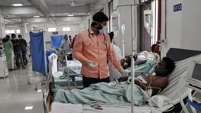 A worker undergoing treatment at Surat civil hospital. (ANI)