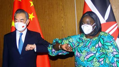 Chinese Foreign Minister Wang Yi and his Kenyan counterpart Raychelle Omamo bump elbows during a news conference in the coastal city of Mombasa, Kenya on Thursday. (REUTERS) Chinese Foreign Minister Wang Yi and his Kenyan counterpart Raychelle Omamo bump elbows during a news conference in the coastal city of Mombasa, Kenya on Thursday. (REUTERS)