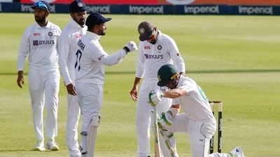 South Africa's Dean Elgar reacts after being hit by the ball on the helmet grill off the bowling of India's Jasprit Bumrah as Virat Kohli checks he is ok (REUTERS)