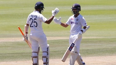 India's Ajinkya Rahane celebrates his half century with Cheteshwar Pujara. (REUTERS)