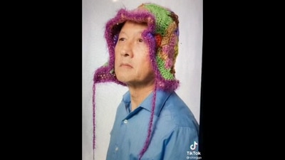 The image taken from the Reddit video shows the dad wearing the daughter's handmade crochet hats. (Reddit/@Eshwarroy)