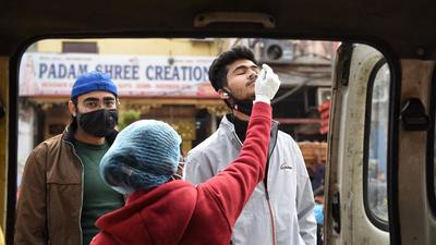 A health worker collects a swab sample to test for Covid-19 Infection, at Chandni Chowk, in New Delhi. (Sanchit Khanna/HT Photo) A health worker collects a swab sample to test for Covid-19 Infection, at Chandni Chowk, in New Delhi. (Sanchit Khanna/HT Photo)