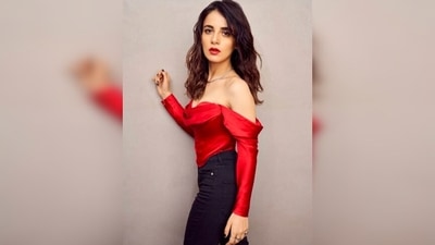 Radhika Madan kept it chic yet casual in a long-sleeve off-shoulder red satin top with a plunging neckline, black bell-bottom denims and pointed heels. (Instagram/@radhikamadan)