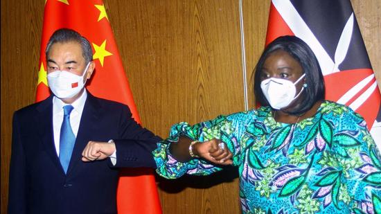 Chinese Foreign Minister Wang Yi and his Kenyan counterpart Raychelle Omamo bump elbows during a news conference in the coastal city of Mombasa, Kenya on Thursday. (REUTERS) Chinese Foreign Minister Wang Yi and his Kenyan counterpart Raychelle Omamo bump elbows during a news conference in the coastal city of Mombasa, Kenya on Thursday. (REUTERS)