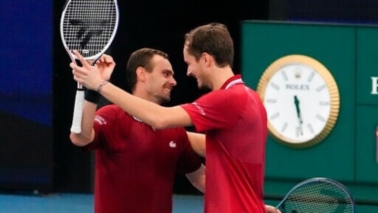 Russia's Danill Medvedev, right, and teammate Roman Safiullin celebrate after defeating Italy's Jannik Sinner and Matteo Berrettini in their doubles match at the ATP Cup tennis tournament in Sydney, Australia.(AP)
