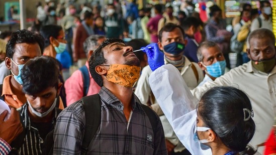 A Brihanmumbai Municipal Corporation (BMC) health worker collects swab samples of outstation passengers for the Covid-19 test at the CSMT Station amid concern over rising Omicron cases in Mumbai. (PTI / File Photo) A Brihanmumbai Municipal Corporation (BMC) health worker collects swab samples of outstation passengers for the Covid-19 test at the CSMT Station amid concern over rising Omicron cases in Mumbai. (PTI / File Photo)