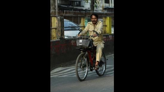 Umesh Shripat Alone, a 58-year-old resident of Khanda Colony in Navi Mumbai, with his electric cycle. (BACHCHAN KUMAR/HT PHOTO)