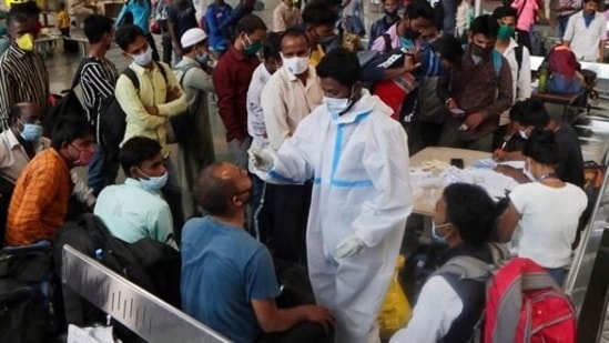 Commuters who arrived by long distance trains wait to test for Covid- 19 at the Chhatrapati Shivaji Maharaj Terminus in Mumbai.(AP) Commuters who arrived by long distance trains wait to test for Covid- 19 at the Chhatrapati Shivaji Maharaj Terminus in Mumbai.(AP)