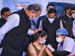 A health worker administers a Covid-19 vaccine to a teenager in presence of Rajasthan Chief Minister Ashok Gehlot, in Jaipur,&nbsp;