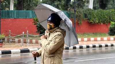 A cop on duty amid the rain in Chandigarh on Friday. (Ravi Kumar/HT) A cop on duty amid the rain in Chandigarh on Friday. (Ravi Kumar/HT)