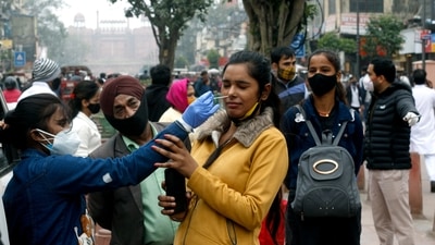A healthcare worker collects a nasal swab sample of a pedestrian at Chandni Chowk on Friday.&nbsp; (ANI)