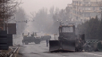 Servicemen and their military vehicles block a street in central Almaty. (AFP) Servicemen and their military vehicles block a street in central Almaty. (AFP)
