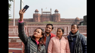 Tourists click a selfie in front of Red Fort, which has been closed like other monuments in the city due to the rising Covid-19 cases. (Photo: Atul Yadav/PTI)