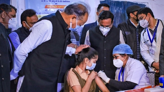 A health worker administers a Covid-19 vaccine to a teenager in presence of Rajasthan Chief Minister Ashok Gehlot, in Jaipur, (PTI)