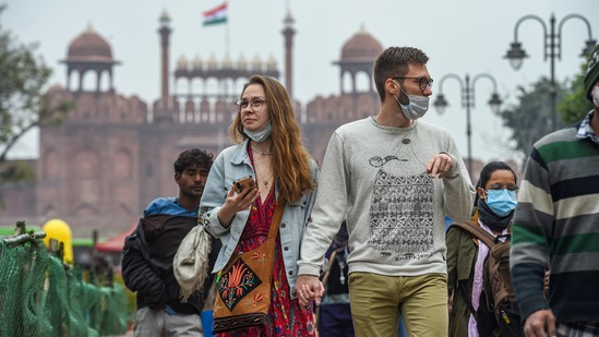 Visitors flout COVID-appropriate behaviour as they walk through the market area of Chandni Chowk in New Delhi on Friday. (PTI) Visitors flout COVID-appropriate behaviour as they walk through the market area of Chandni Chowk in New Delhi on Friday. (PTI)